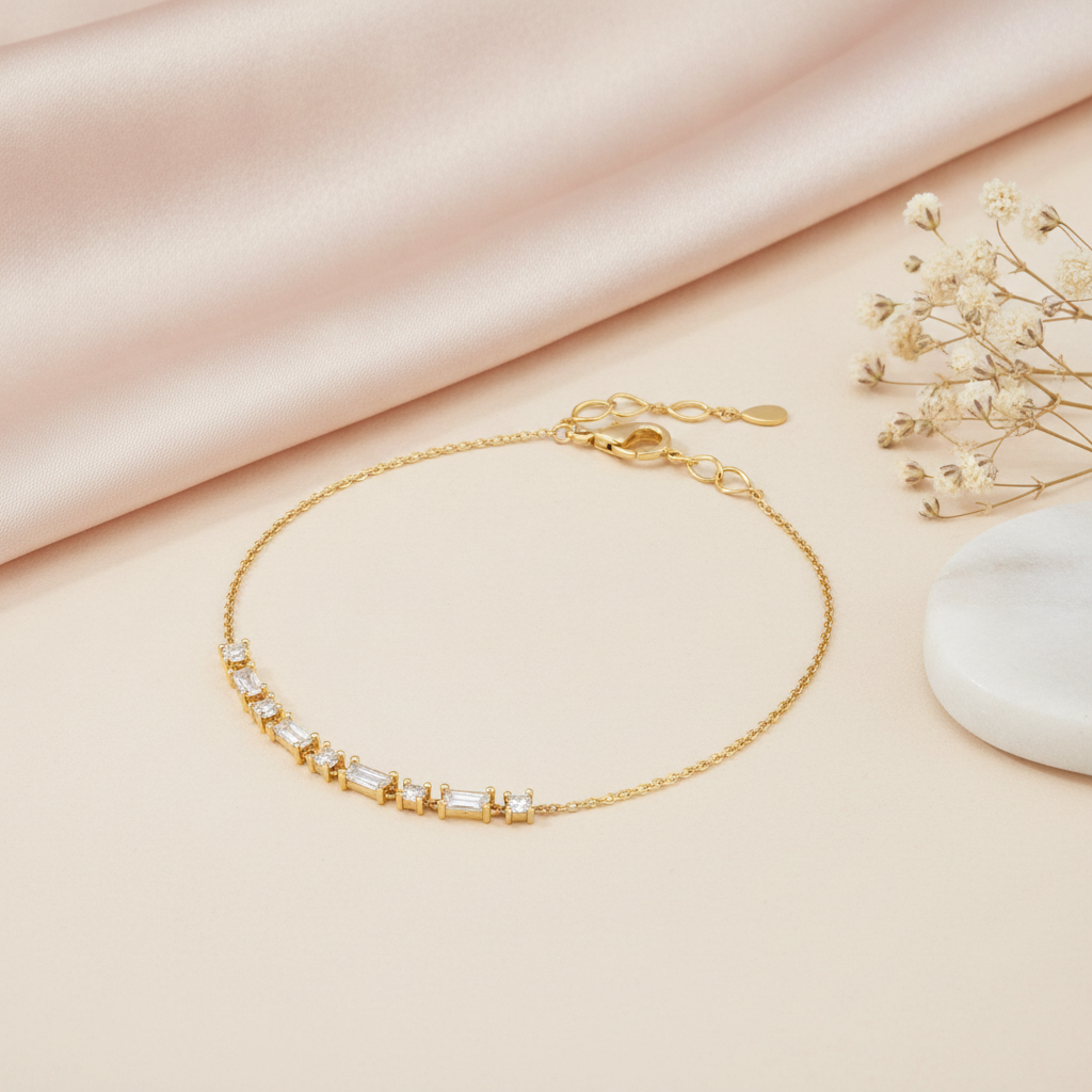 gold baguette chain bracelet on blush satin with dried flowers