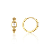 yellow gold chain-link huggie hoop earrings with baguette stone on white background
