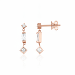 rose gold articulated drop earrings with baguette and square stones on white background