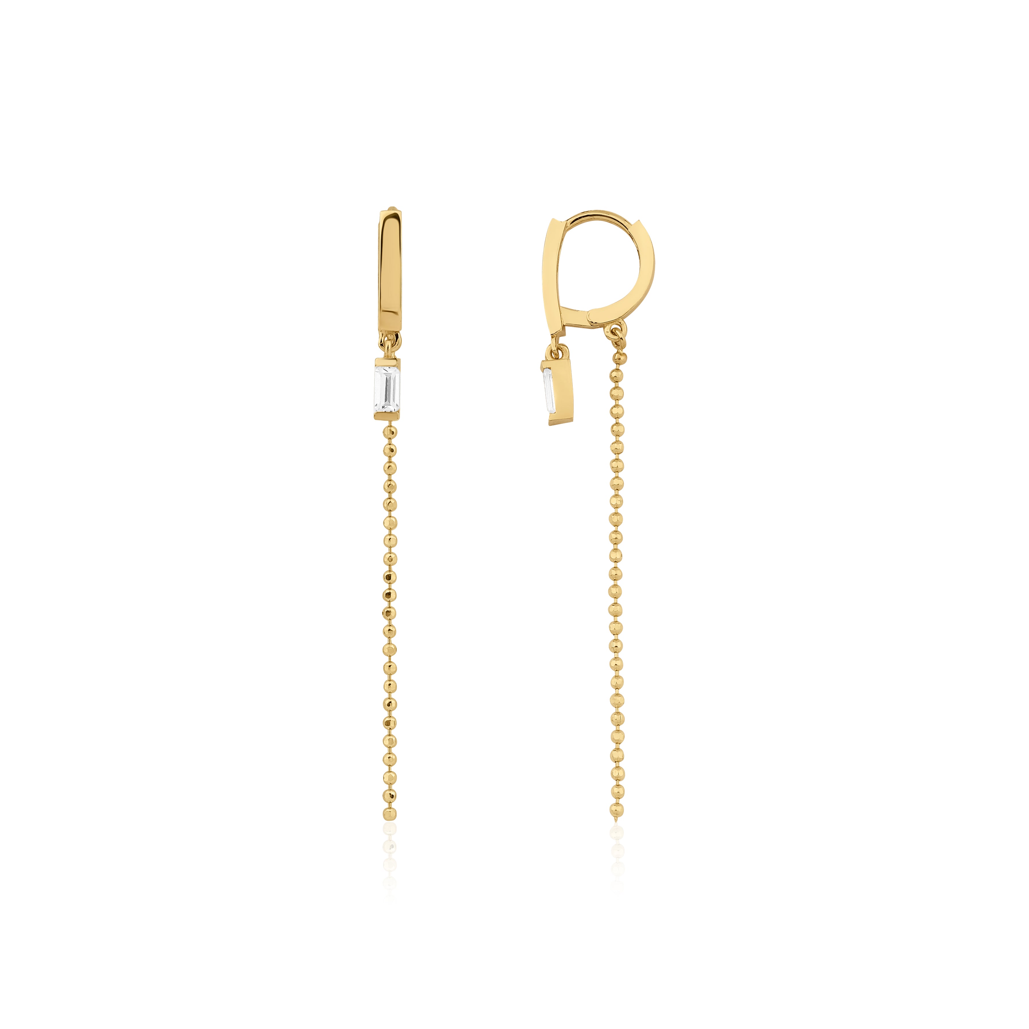 yellow gold huggie hoop earrings with baguette stone and beaded chain drop on white background