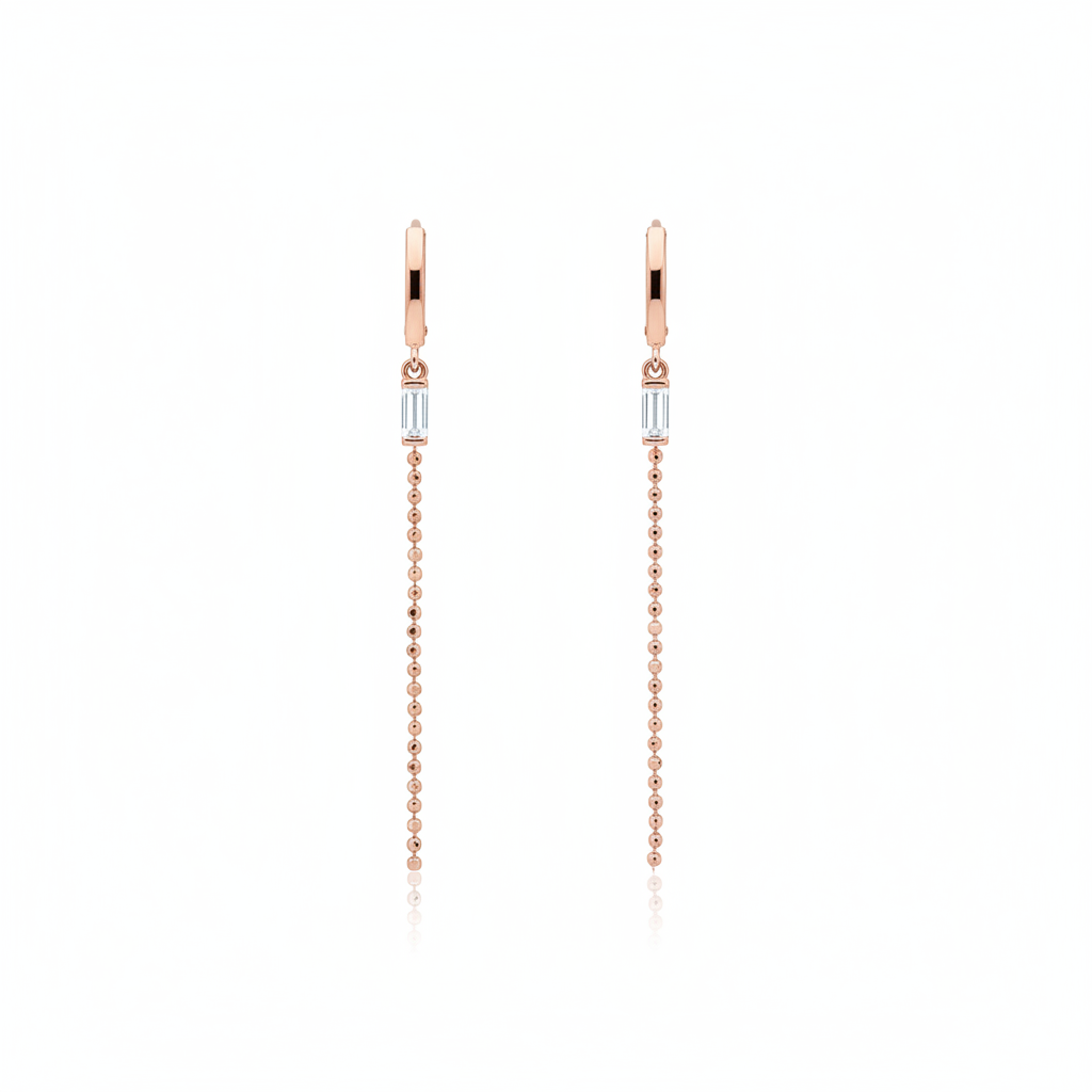 rose gold huggie hoop earrings with baguette stone and beaded chain drop on white background