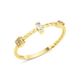 yellow gold twisted ring with baguette and square cluster stones on white background