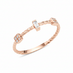 rose gold twisted ring with baguette and square cluster stones on white background