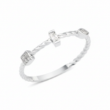 white gold twisted ring with baguette and square cluster stones on white background