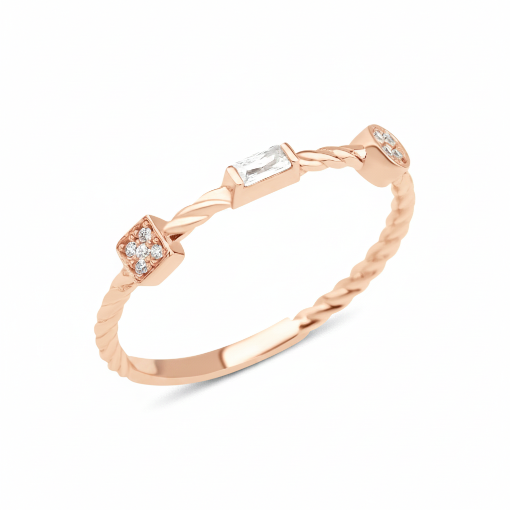 rose gold twisted ring with square, baguette, and bezel stones on white background
