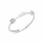 white gold twisted ring with square, baguette, and bezel stones on white background
