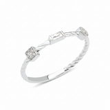 white gold twisted ring with square, baguette, and bezel stones on white background