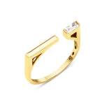 yellow gold open ring with polished bar and baguette stone on white background