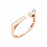 rose gold open ring with polished bar and baguette stone on white background