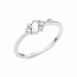 white gold ring with baguette stone and round accent cluster on white background