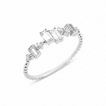 white gold beaded ring with baguette and round stones on white background