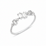 white gold beaded ring with baguette and round stones on white background