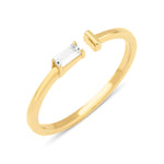 yellow gold open ring with baguette stone and smooth bar on white background
