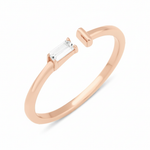 rose gold open ring with baguette stone and smooth bar on white background