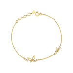 yellow gold butterfly charm bracelet on white background