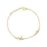 yellow gold butterfly charm bracelet on white background