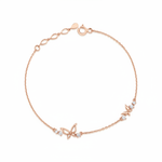 rose gold butterfly charm bracelet on white background