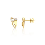 yellow gold wing stud earrings with pave stones on white background