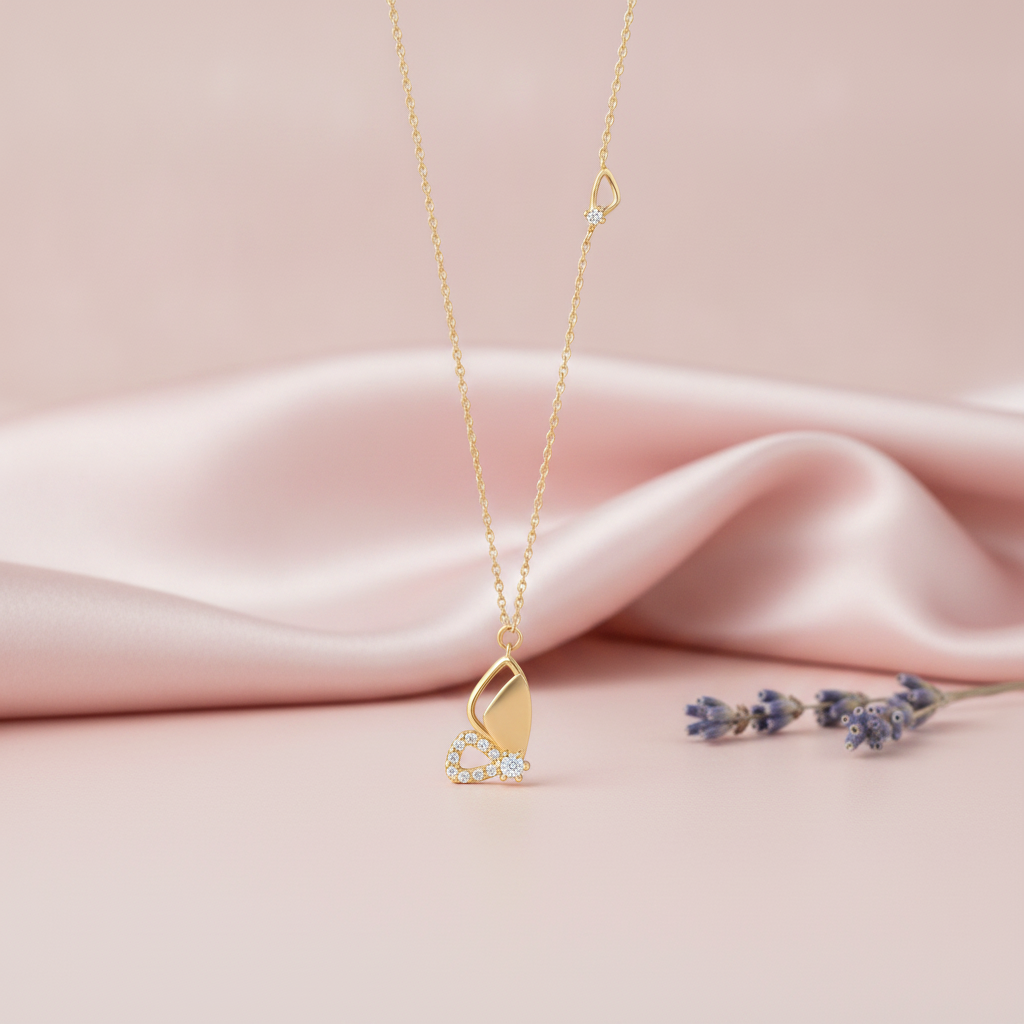 asymmetrical gold butterfly pendant necklace with clear stones on pink satin with lavender sprigs