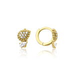 yellow gold huggie hoops with beaded teardrop and pear-cut stone drop on white background