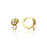 yellow gold huggie hoops with beaded teardrop and pear-cut stone drop on white background