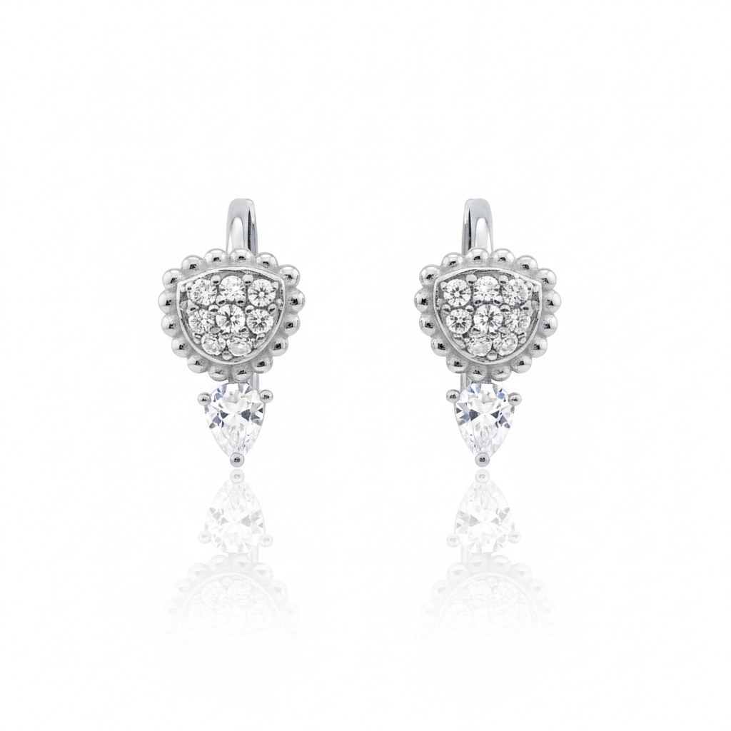 white gold huggie hoops with beaded teardrop and pear-cut stone drop on white background