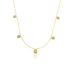yellow gold teardrop station necklace on white background