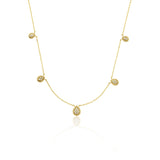 yellow gold teardrop station necklace on white background