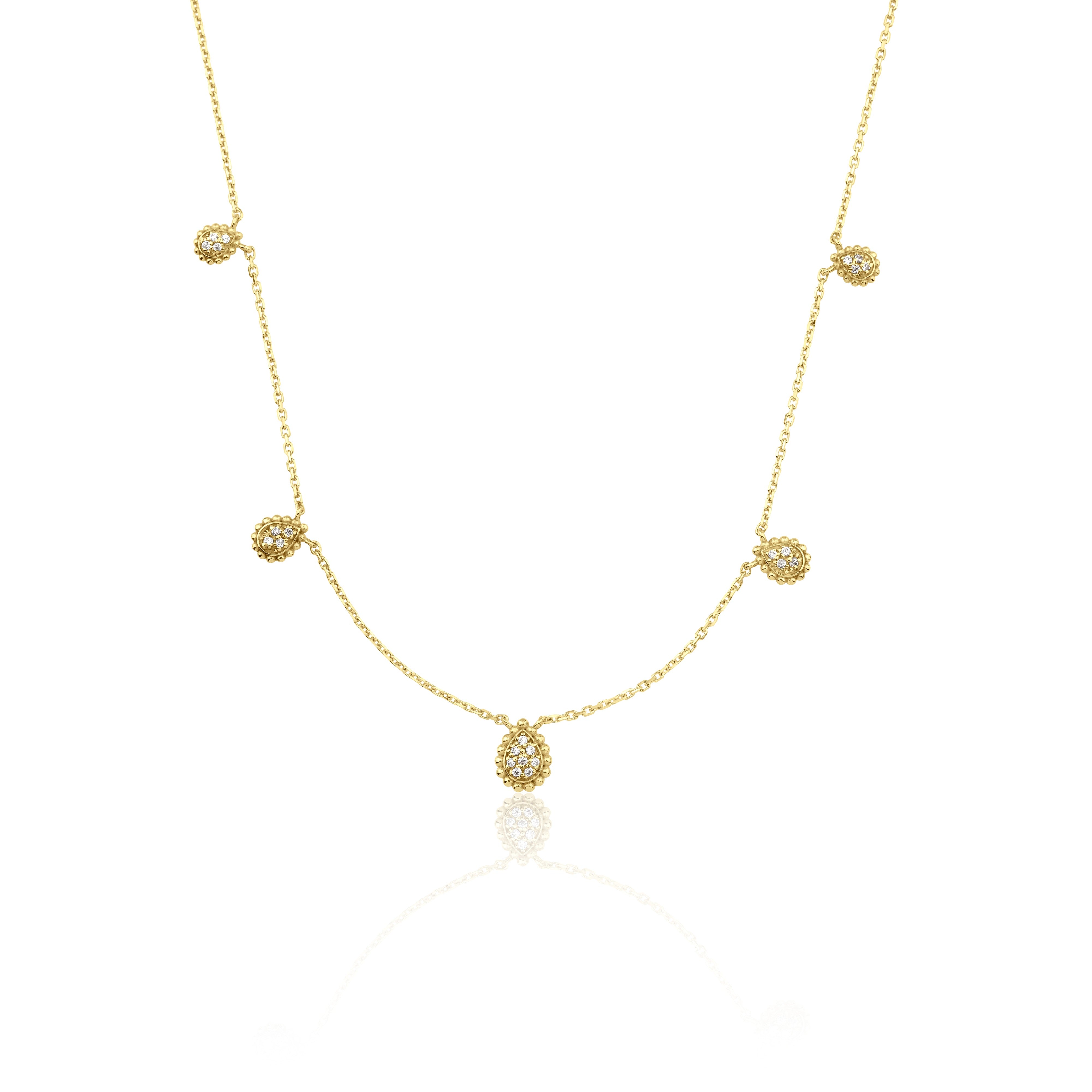 yellow gold teardrop station necklace on white background