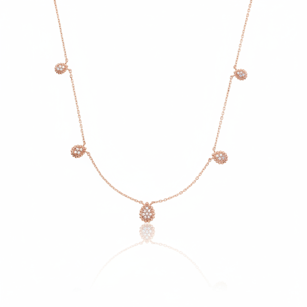 rose gold teardrop station necklace on white background