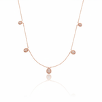 rose gold teardrop station necklace on white background