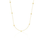 yellow gold faceted nugget station necklace on a white background