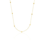 yellow gold faceted nugget station necklace on a white background