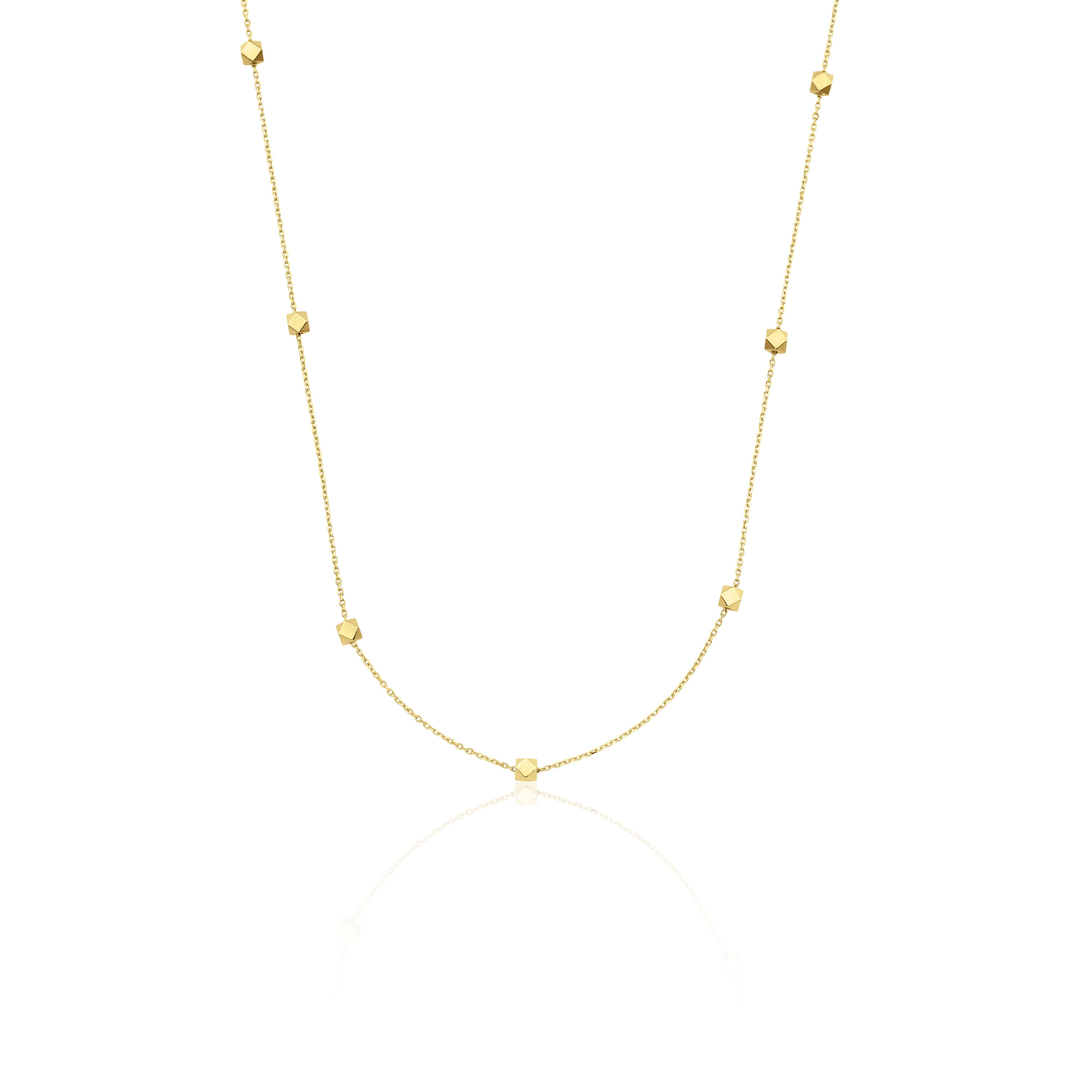 yellow gold faceted nugget station necklace on a white background