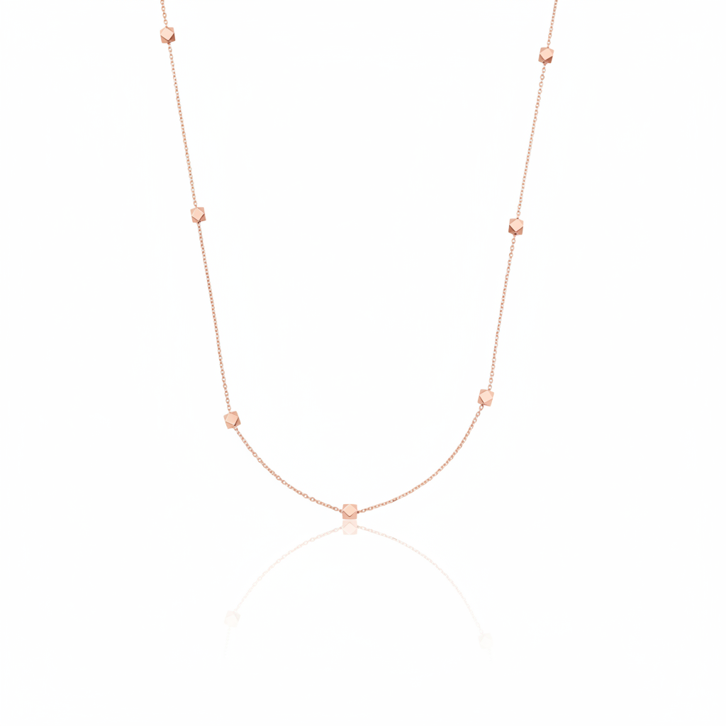 rose gold faceted nugget station necklace on a white background