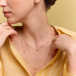 model wearing the gold long station necklace