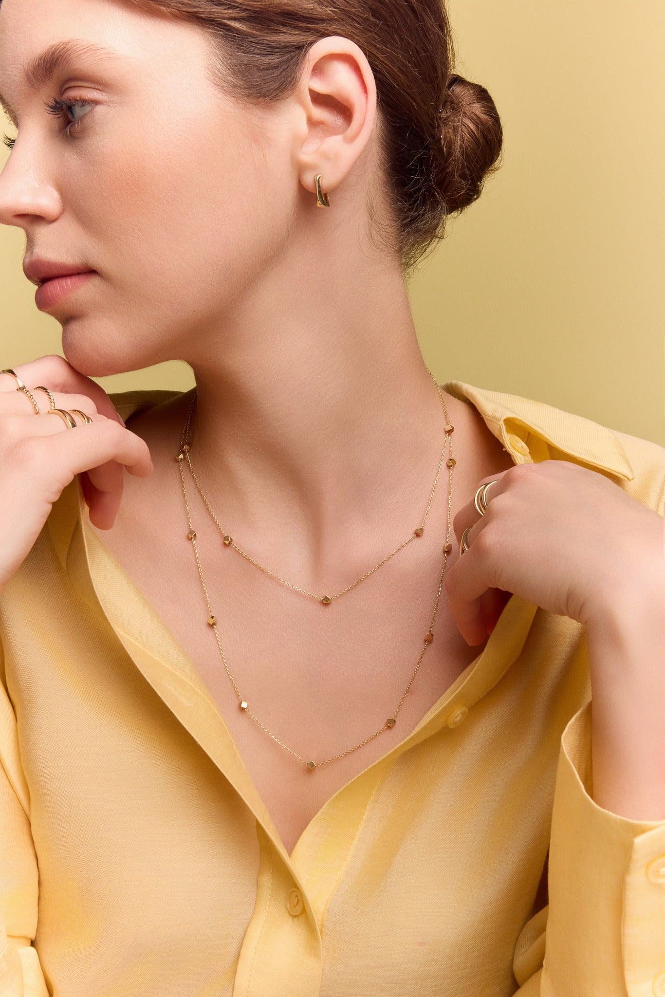model wearing the gold long station necklace