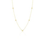 yellow gold faceted nugget station necklace on a white background