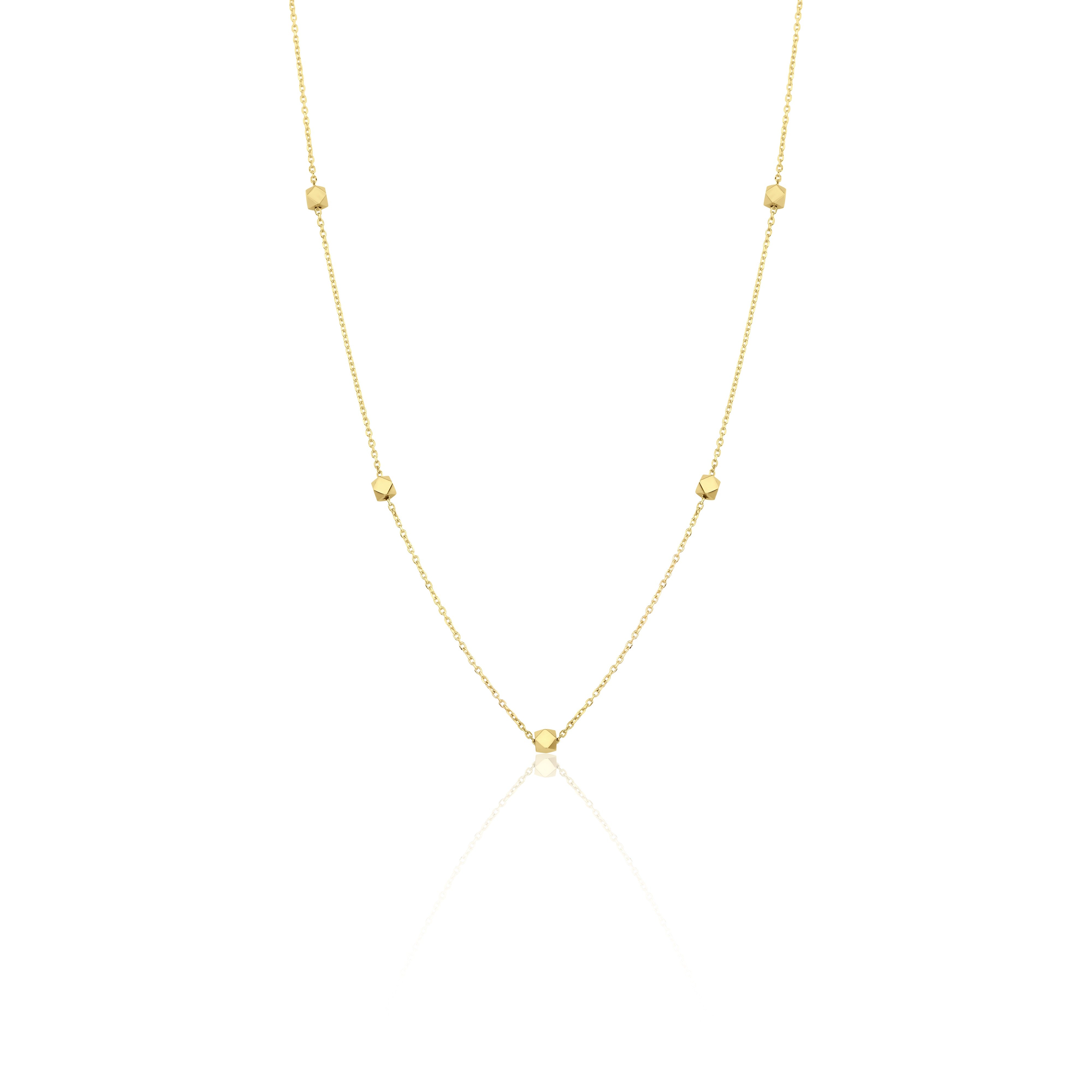 yellow gold faceted nugget station necklace on a white background