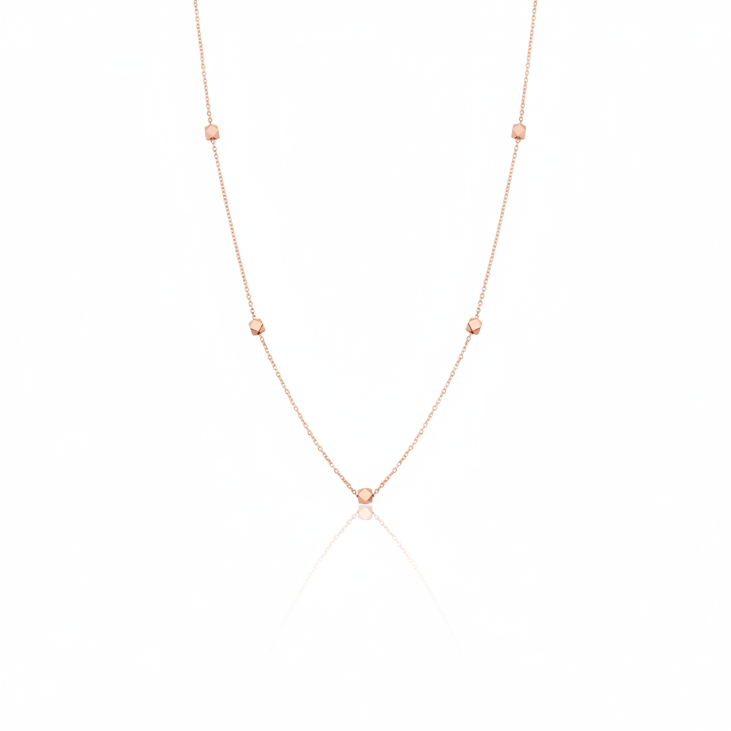 rose gold faceted nugget station necklace on a white background
