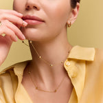 model wearing the gold collarbone station necklace