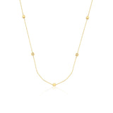 yellow gold faceted nugget station necklace with small stone accents on a white background