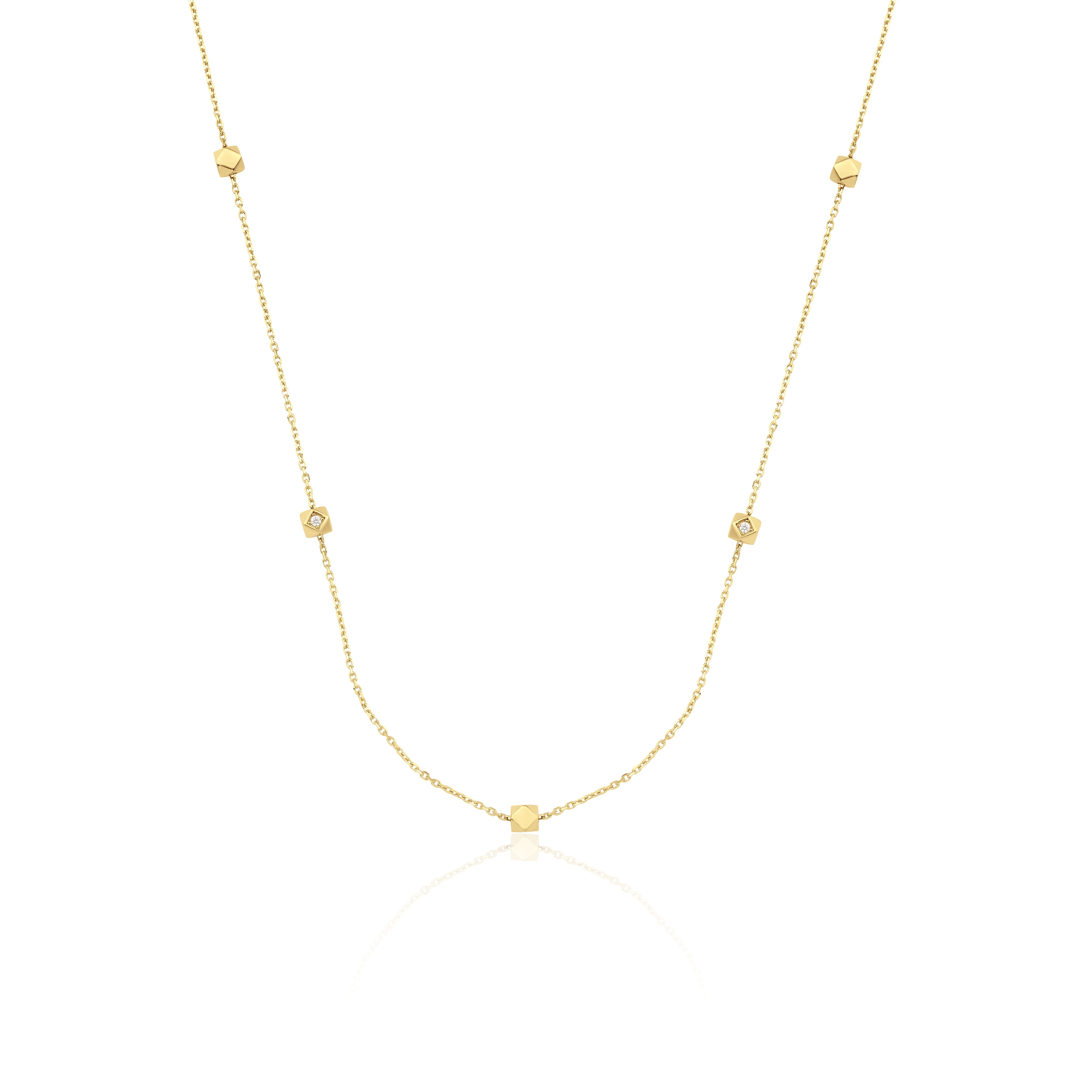 yellow gold faceted nugget station necklace with small stone accents on a white background