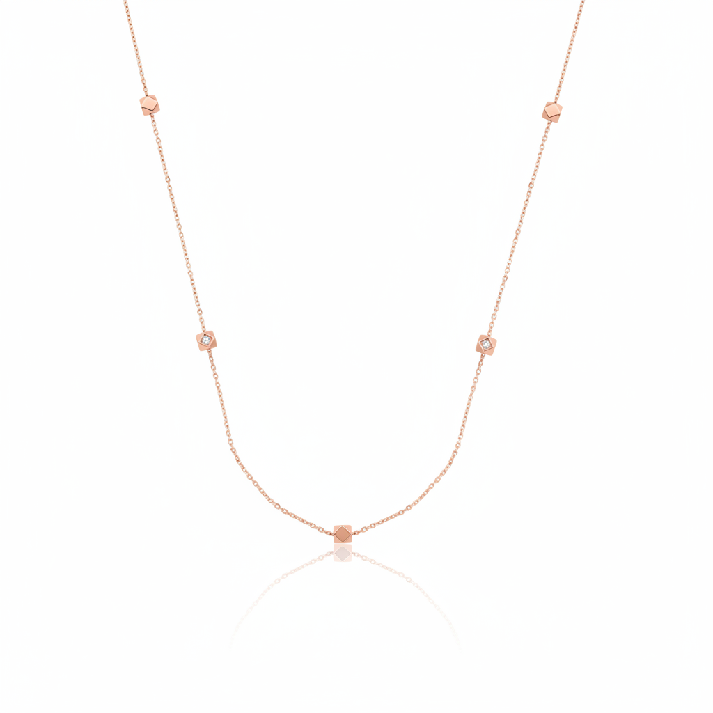 rose gold faceted nugget station necklace with small stone accents on a white background