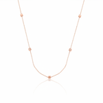 rose gold faceted nugget station necklace with small stone accents on a white background