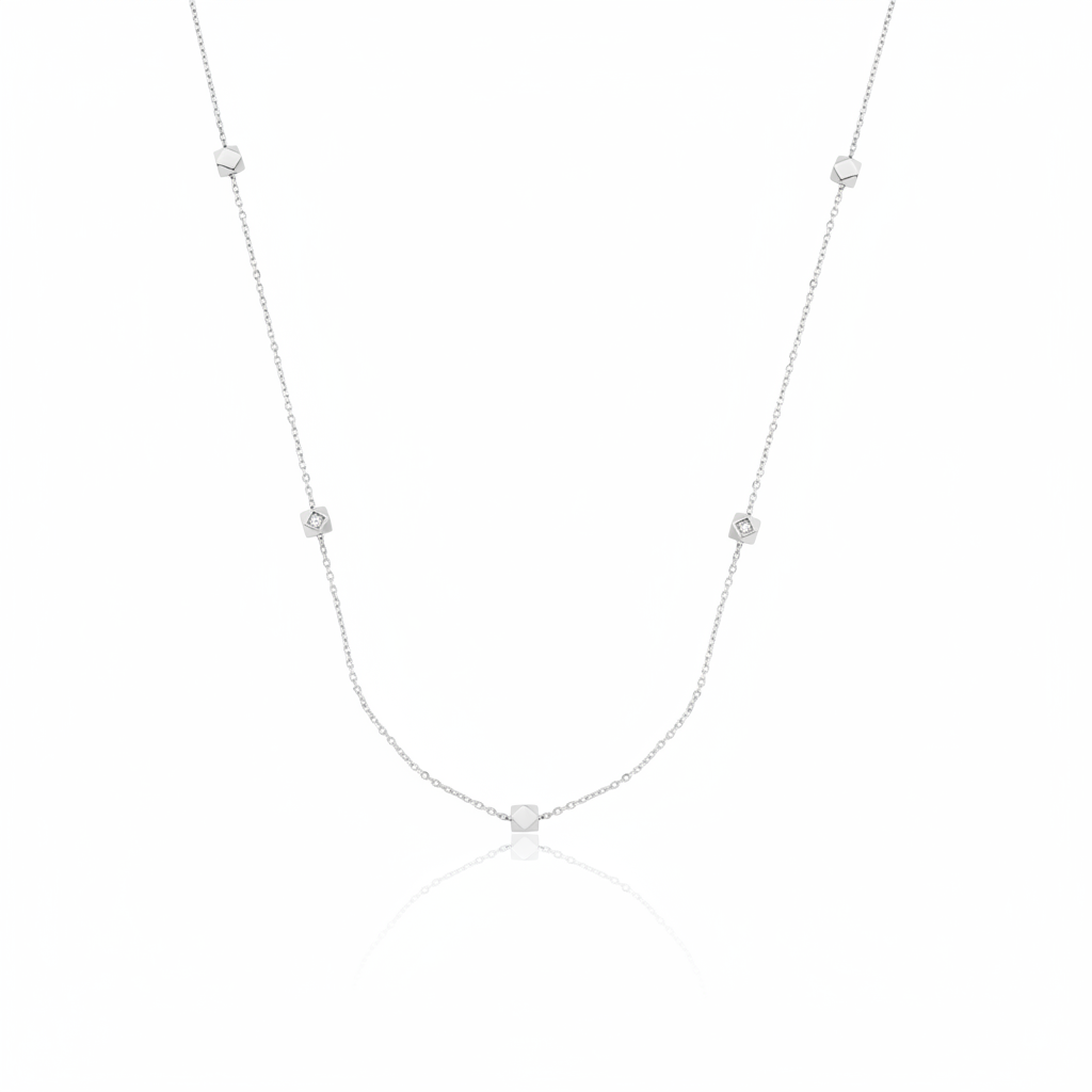 white gold faceted nugget station necklace with small stone accents on a white background