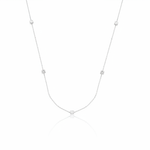 white gold faceted nugget station necklace with small stone accents on a white background