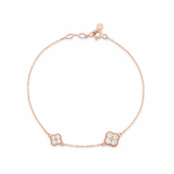 rose gold clover charm bracelet with White CZ stones on white background