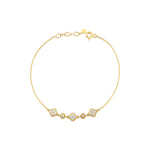yellow gold clover and round link station bracelet with White CZ stones on white background