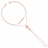 rose gold hand chain bracelet with bezel-set stones and a floral motif drop on white background